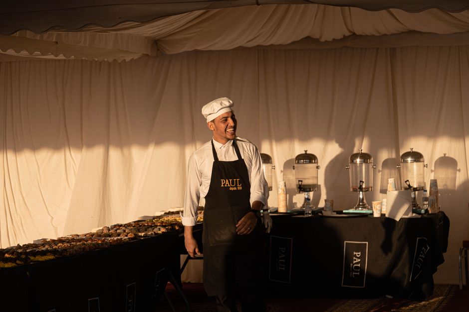 Smiling catering staff preparing food for an event