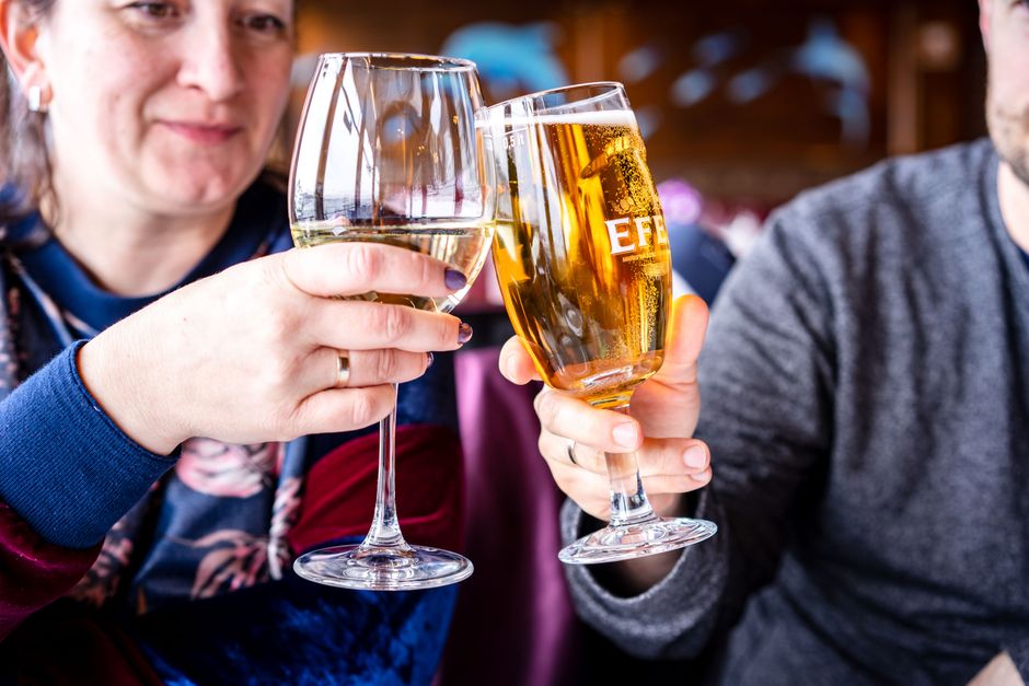 People clinking wine glasses at a catered private party